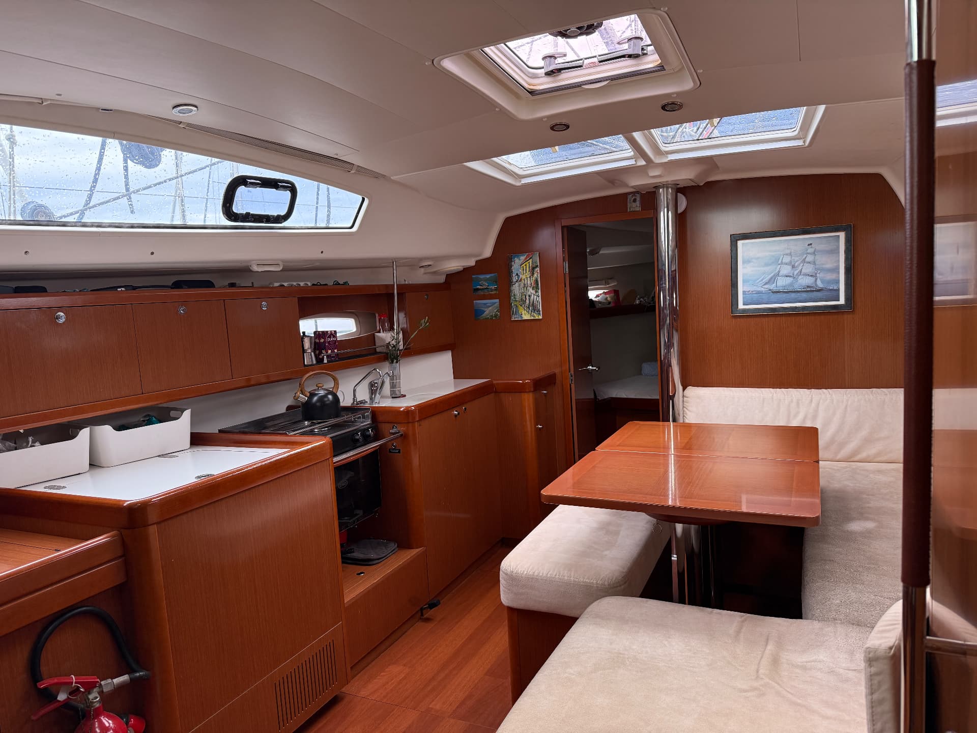 Galley and saloon with skylights and dining table
