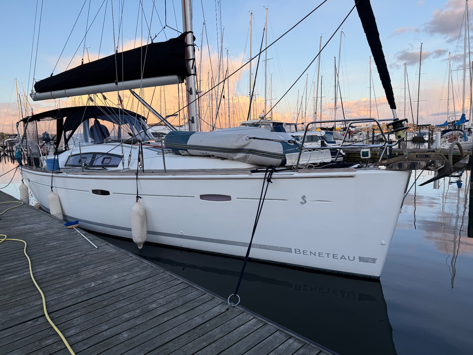 Beneteau Oceanis 40 Topas at the dock at sunset with dinghy on deck