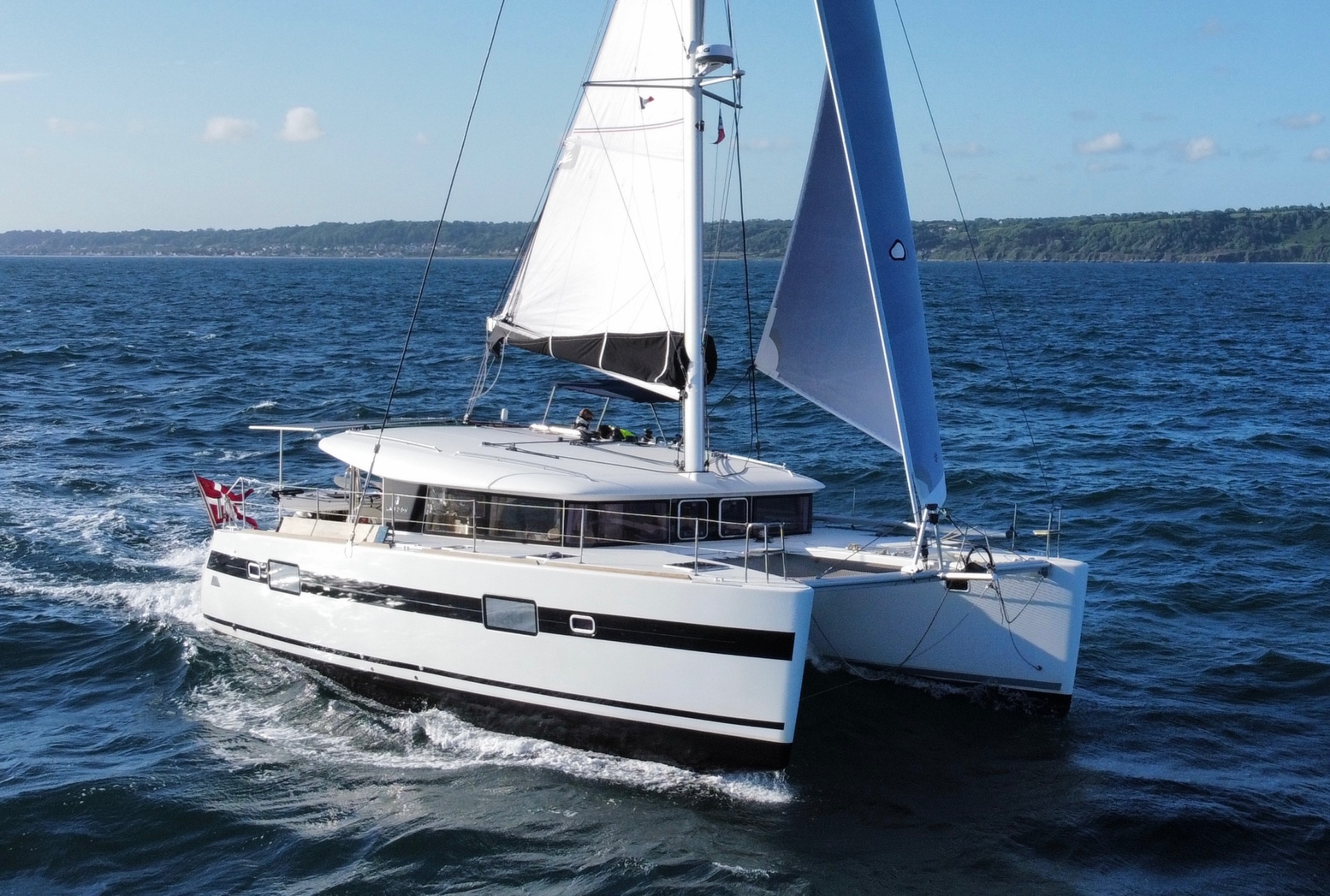 Serendipity under full sail seen from the water