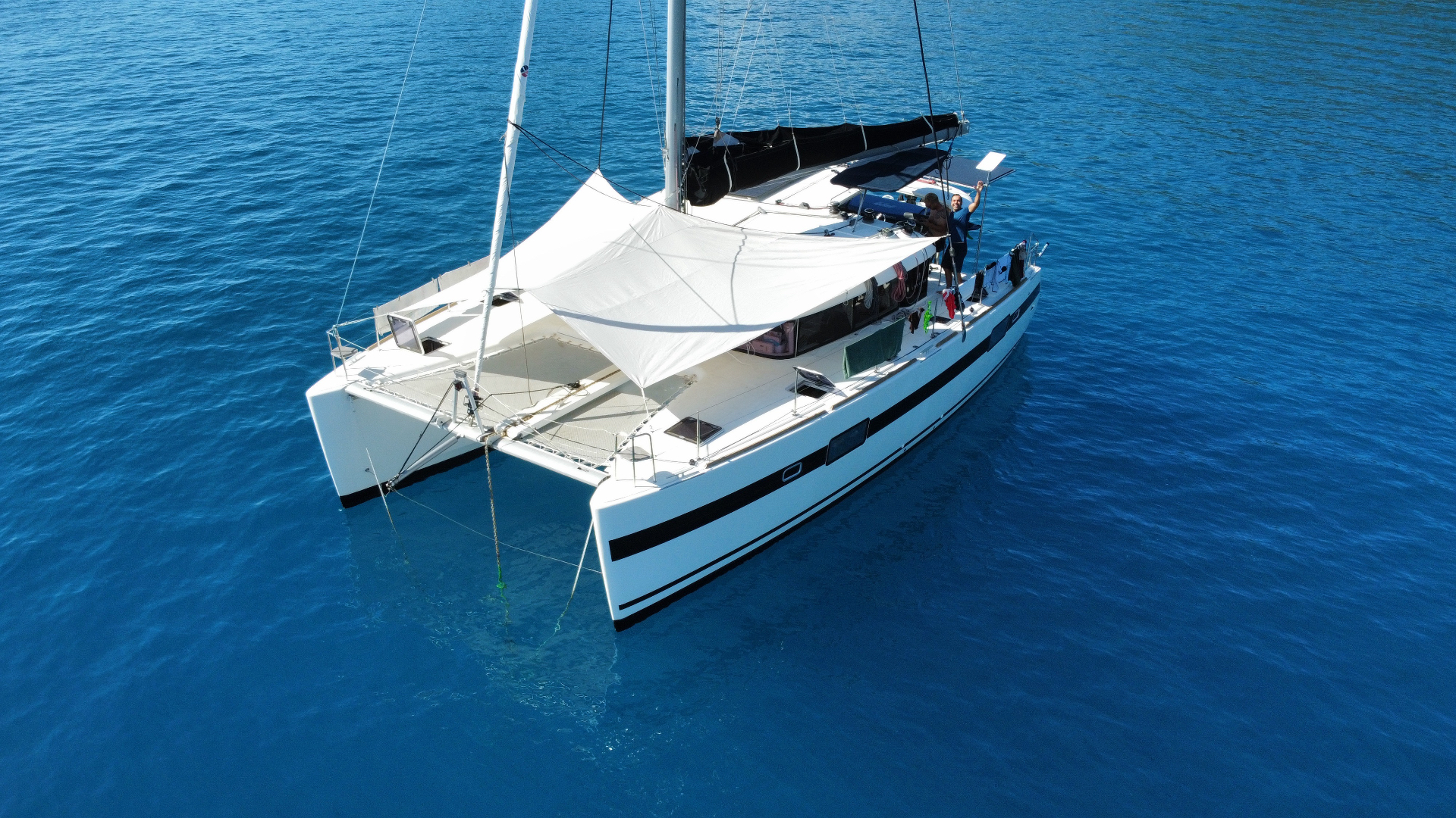 Sun awning rigged over the catamaran at anchor
